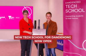 Gabrielle Williams stands beside the commemorative opening plague for the Tech School in Dandenong
